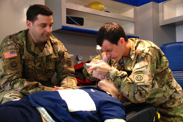 Staff Sgt. James Soroka, left, and Sgt. Brandon Dukes, both medics assigned to the 82nd Combat Aviation Brigade practice endotracheal intubation, March 3, 2016. Both Soldiers are attending paramedic training at Fayetteville Technical Community Col. (Photo Credit: U.S. Army)